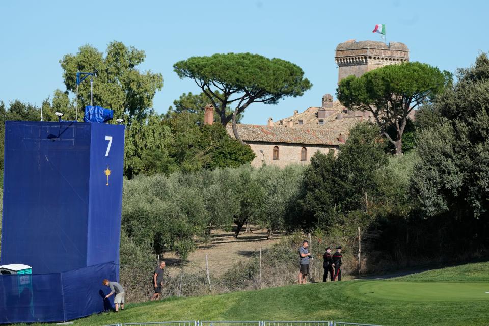 Backdropped by the 11th-century castle belonging to fashion designer and owner of the Marco Simone Golf Club Lavinia Biagiotti Cigna, workers put on the final touches to the course at the Marco Simone Golf Club in Guidonia Montecelio, Italy, Monday, Sept. 25, 2023. The Marco Simone Club on the outskirts of Rome will host the 44th edition of The Ryder Cup, the biennial competition between Europe and the United States headed to Italy for the first time. (AP Photo/Alessandra Tarantino)