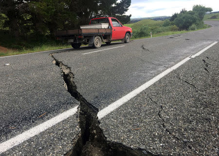 A truck drives over the fractured road caused by an earthquake south of the New Zealand town of Ward on the South Island, November 14, 2016. REUTERS/Anthony Phelps