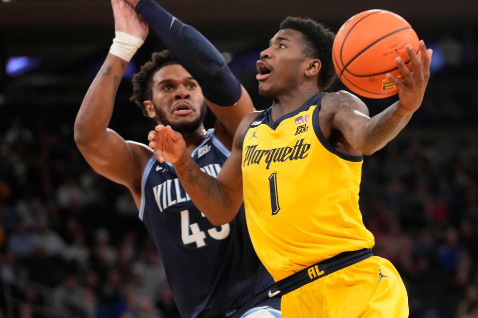 Marquette guard Kam Jones (1) goes to the basket against Villanova forward Eric Dixon (43) during the first half of an NCAA college basketball game in the quarterfinal round of the Big East Conference tournament, Thursday, March 14, 2024, in New York. (AP Photo/Mary Altaffer)