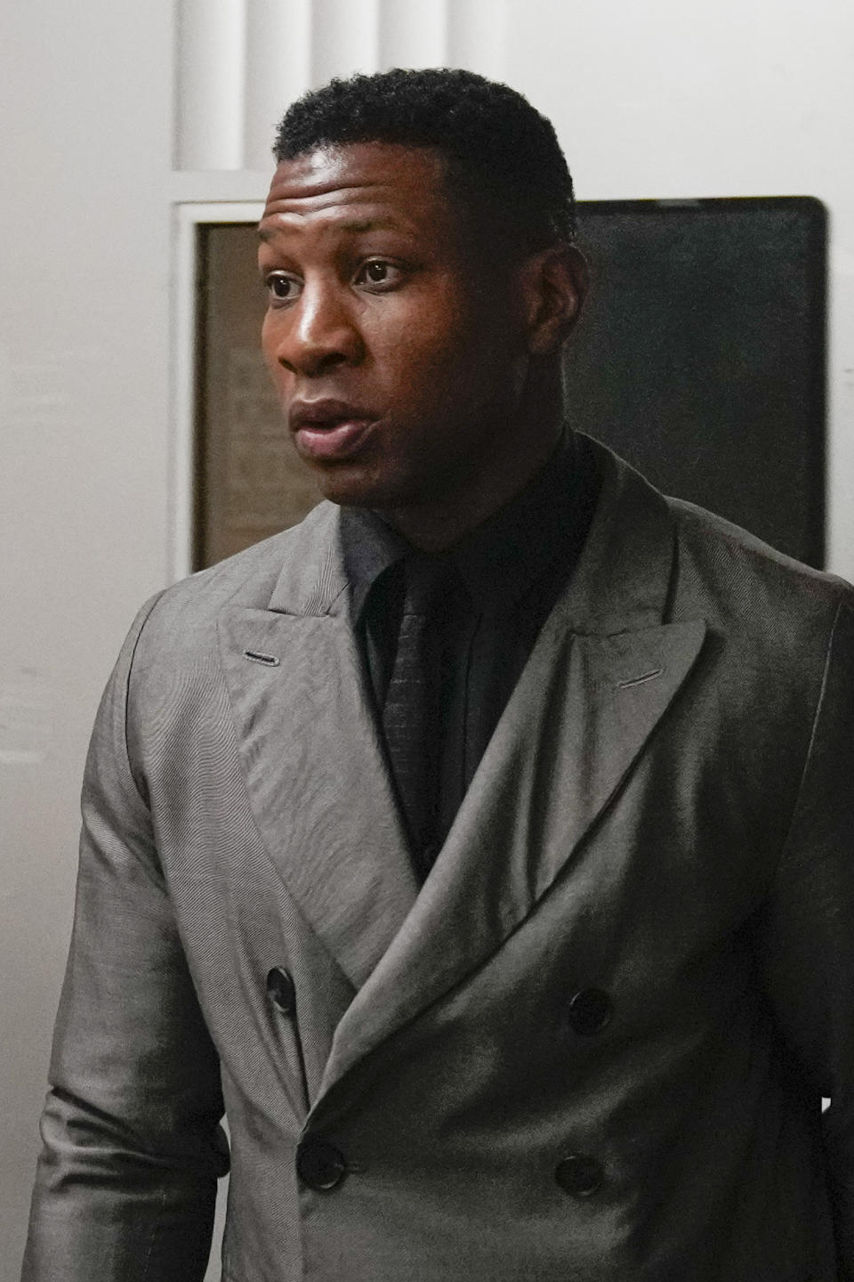 Jonathan Majors leaves a courtroom at the Manhattan criminal courts in New York, Monday, Dec. 18, 2023. The actor is accused of assaulting his then-girlfriend as the two struggled over a phone in the back seat of a chauffeured car. (AP Photo/Seth Wenig)