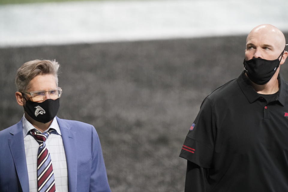 FILE - In this Sept. 27, 2020, file photo, Atlanta Falcons general manager Thomas Dimitroff, left, speaks with Falcons head coach Dan Quinn before an NFL football game against the Chicago Bears, in Atlanta. Atlanta coach Dan Quinn has been fired after the Falcons dropped to 0-5 for the first time since 1997. The move came just hours after the Falcons lost to the Carolina Panthers 23-16, Sunday, Oct. 11, 2020. The team also fired longtime general manager Thomas Dimitroff, who had been with the team since 2008. (AP Photo/Brynn Anderson, File)