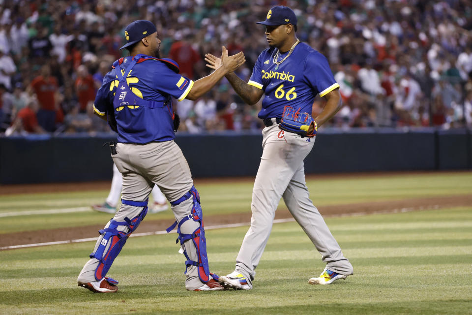 Mar 11, 2023; Phoenix, Arizona, USA; Team Colombia pitcher Guillermo Zu–iga (66) celebrates with catcher Elias D’az (35) after the final out during the tenth inning against Team Mexico at Chase Field. Mandatory Credit: Chris Coduto-USA TODAY Sports