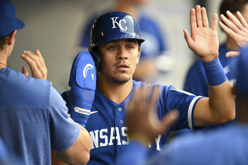 Kansas City Royals' Nicky Lopez celebrates with teammates after scoring on a triple by Bobby Witt Jr. during the fifth inning of a baseball game against the Cleveland Guardians, Saturday, July 8, 2023, in Cleveland. (AP Photo/Nick Cammett)