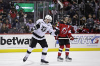 Los Angeles Kings right wing Carl Grundstrom (91) reacts after scoring a goal in front of New Jersey Devils left wing Jimmy Vesey during the third period of an NHL hockey game Sunday, Jan. 23, 2022, in Newark, N.J. (AP Photo/Adam Hunger)