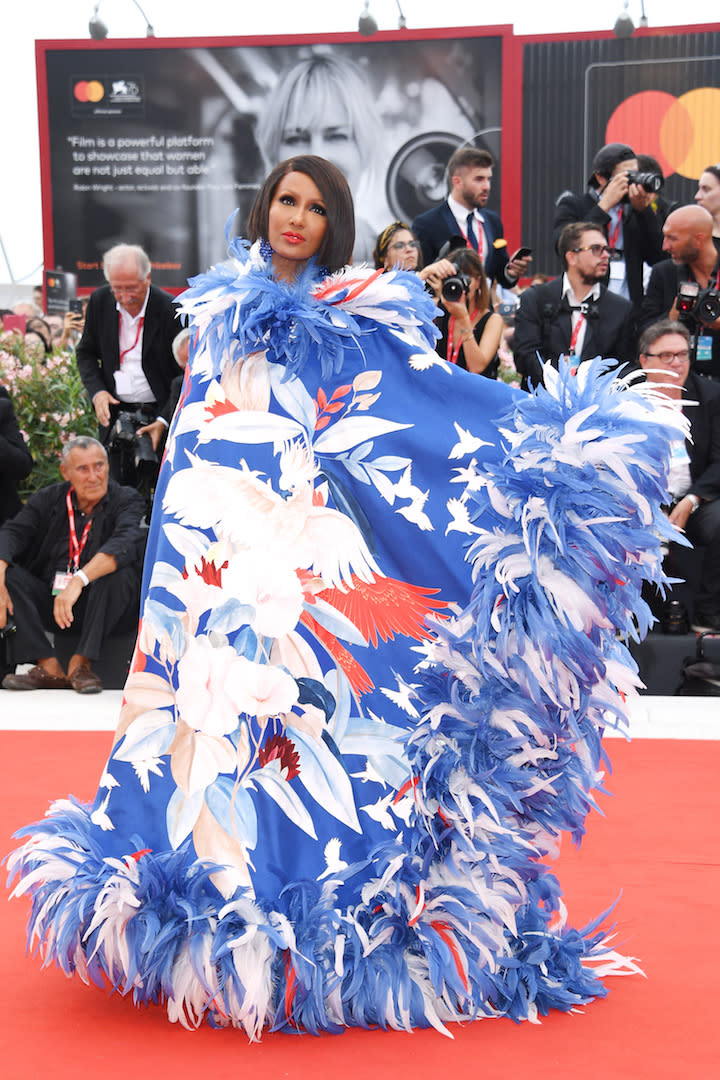 Setting the fashion bar high for fellow attendees, Iman chose a feathered Valentino cape for the grand opening ceremony. <em>[Photo: Getty]</em>