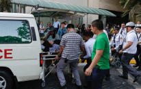 Rescue workers carry a woman to an ambulance after she became dizzy following an earthquake hit Manila, Philippines Monday, April 22, 2019. A strong earthquake has shaken the area around the Philippine capital, prompting thousands of people to flee to safety. There were no immediate reports of injuries or widespread damage. The U.S. Geological Survey says the magnitude 6.3 quake struck northwest of Manila, Monday, near the town of Gutad on Luzon island. (AP Photo/Aaron Favila)