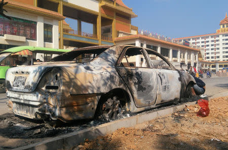 A burnt car is seen after fighters of the Myanmar National Democratic Alliance Army (MNDAA) launched an attack on March 6 on police, military, and government sites in Laukkai, Myanmar March 7, 2017. REUTERS/Stringer