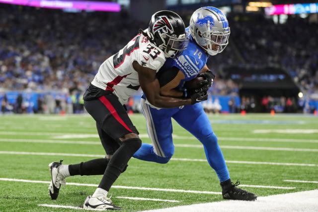 Detroit Lions wide receiver Amon-Ra St. Brown (14) runs a route