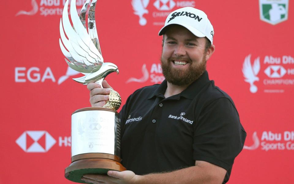 Shane Lowry lifts the trophy after banishing the demons of the US Open - AP