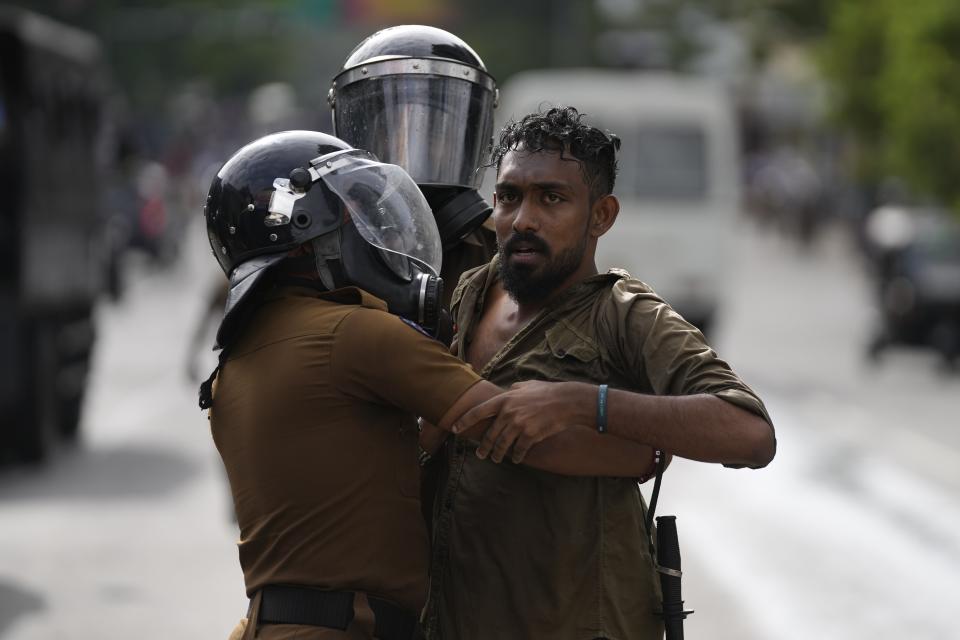 Police officers detain an anti-government protester in Colombo, Sri Lanka, Thursday, Aug. 18, 2022. Sri Lanka’s economic meltdown has triggered a political crisis, with widespread anti-government protests erupting across the country. Massive public protests ousted Sri Lankan President Gotabaya Rajapaksa last month. (AP Photo/Eranga Jayawardena)