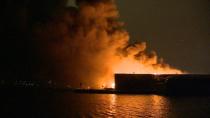 Firefighters return to scene of waterfront recycling plant blaze to put out small fires