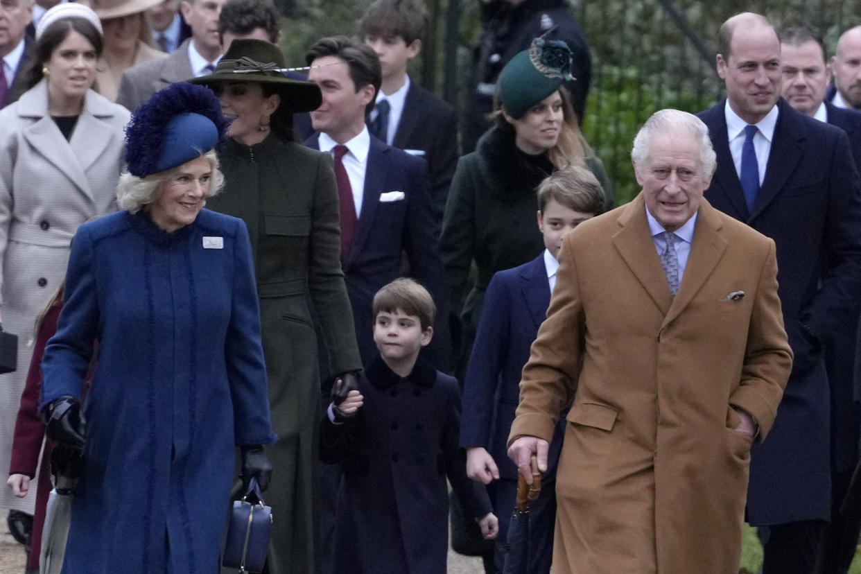 King Charles III, right, and Camilla, the Queen Consort lead the Royal Family as they arrive to attend the Christmas day service at St Mary Magdalene Church in Sandringham in Norfolk, England, Sunday, Dec. 25, 2022. (AP Photo/Kirsty Wigglesworth)