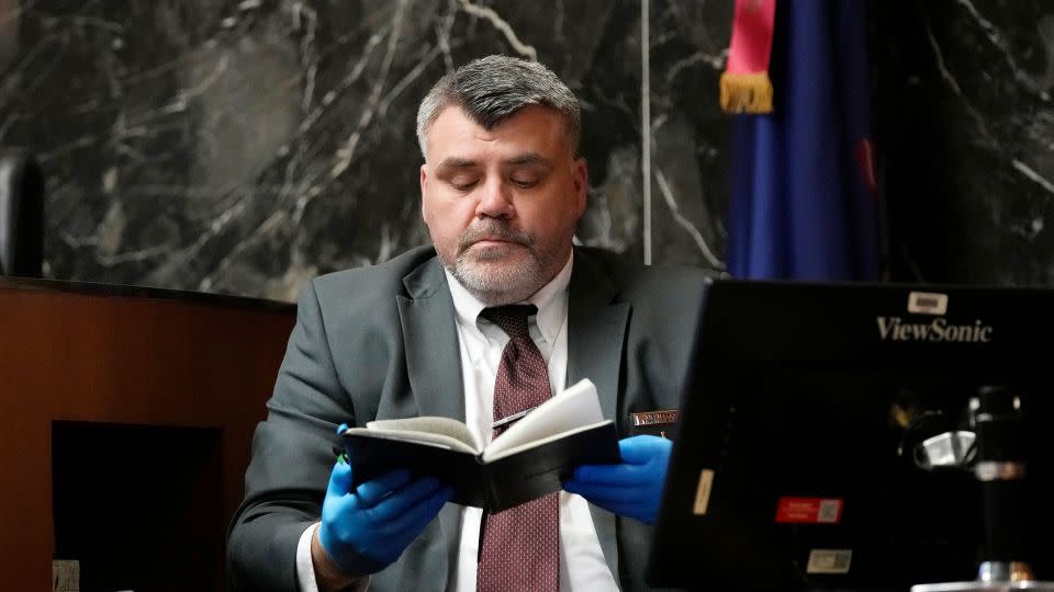 Oakland County Sheriff’s Office Det. Lt. Timothy Willis holds up Ethan Crumbley's journal during the trial of James Crumbley on Tuesday, March 12. - Carlos Osorio/Pool/AP