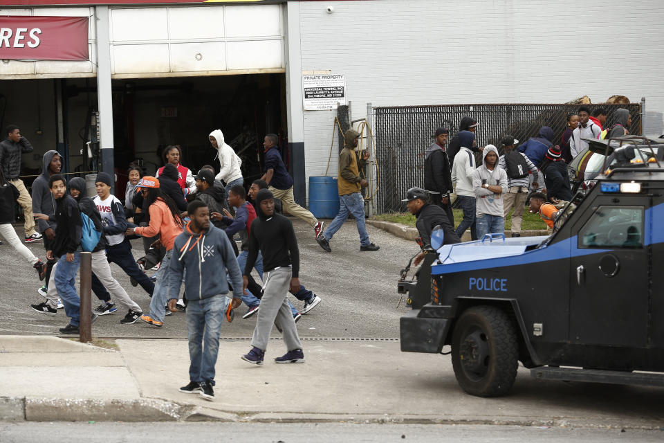 A police vehicle chases protestors away in a parking lot along Reisterstown Road near Mondawmin Mall, April 27, 2015 in Baltimore, Maryland. A group of young protestors clashed with police in the streets near Mondawmin Mall in the afternoon following Freddie Gray's funeral. (Photo by Drew Angerer/Getty Images)