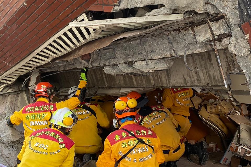 Members of a rescue team searching for survivors in a damaged building in Hualien on April 3, 2024.