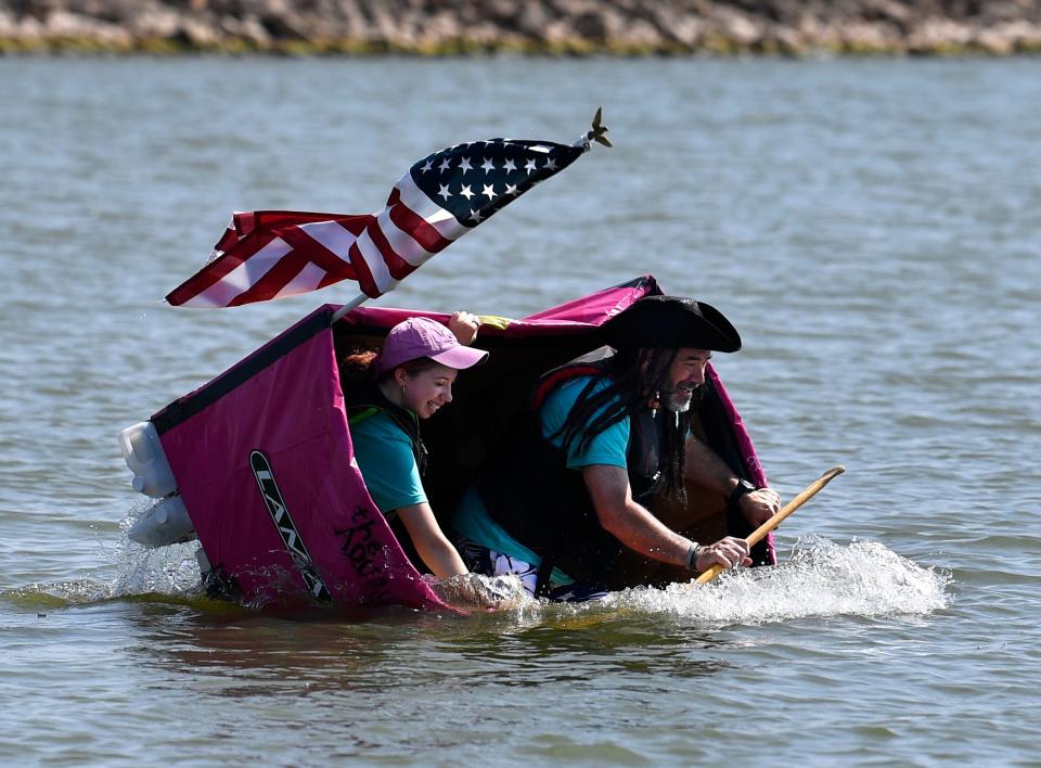 Abilene City Councilman Kyle McAlister and Qeylee Sewell fall into the water as their vessel, the Aquaholic, swamps and tips over. The crew was racing for Lamar Advertising.