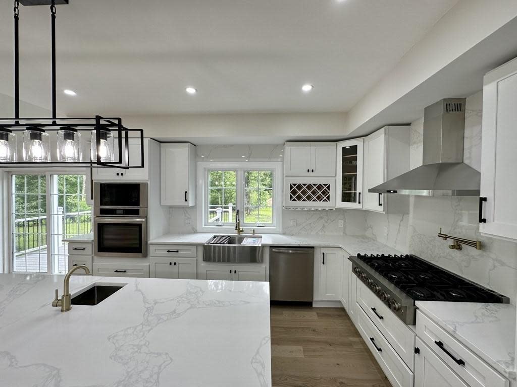 This single-family house at 15 Briarcliff Road in Brockton sold for $850,000 on Sept. 22, 2023. This house boasts custom-built white cabinets with wine rack, Quartz countertops and backsplash, kitchen island with wet bar, pendant lights, and stainless steel appliances. The property was sold by Victor Rosario, Rosario Real Estate LLC.
