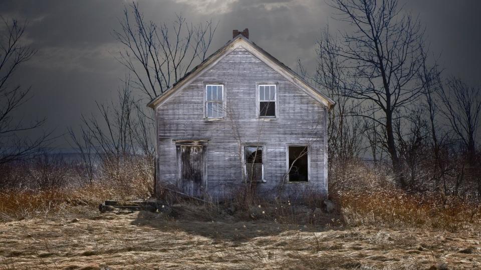 abandoned house under ominous clouds