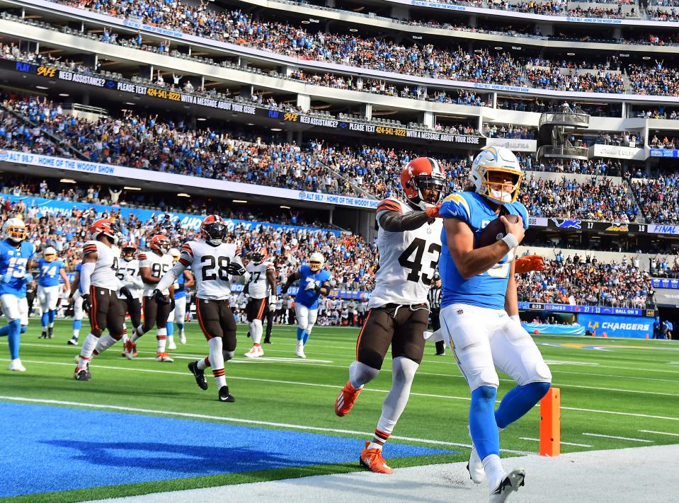 Oct 10, 2021; Inglewood, California, USA; Los Angeles Chargers quarterback Justin Herbert (10) runs the ball for a touchdown ahead of Cleveland Browns free safety John Johnson (43) during the second half at SoFi Stadium. Mandatory Credit: Gary A. Vasquez-USA TODAY Sports