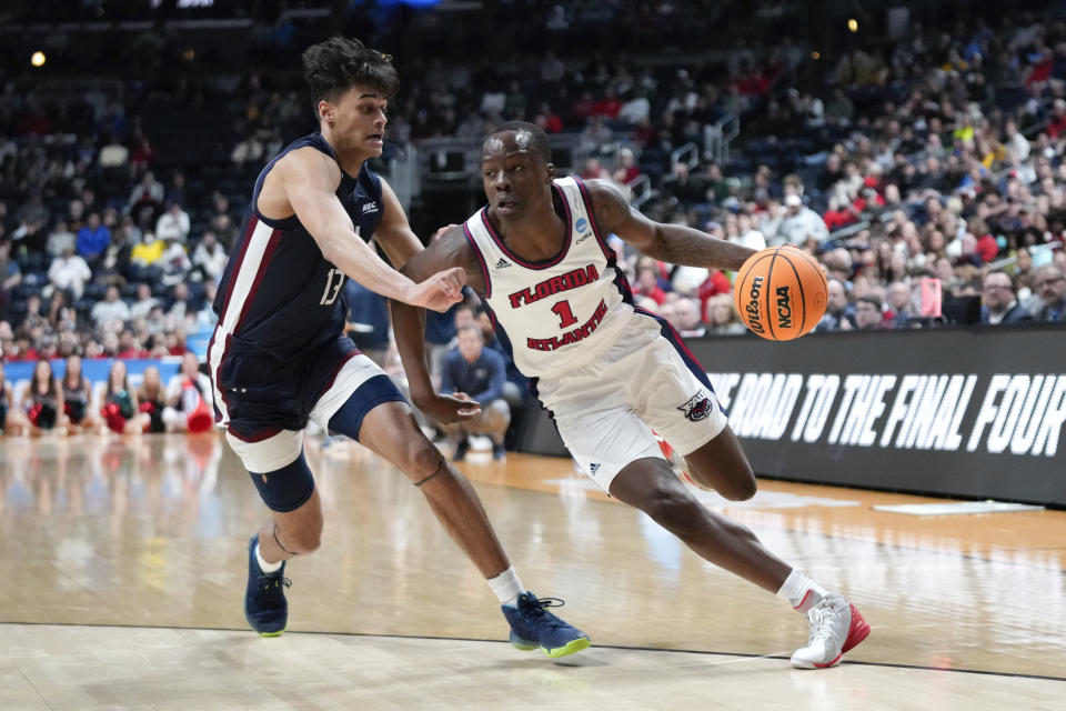 Florida Atlantic guard Johnell Davis (1) drives on Fairleigh Dickinson forward Jo'el Emanuel (13) in the first half of a second-round men's college basketball game in the NCAA Tournament Sunday, March 19, 2023, in Columbus, Ohio. (AP Photo/Paul Sancya)