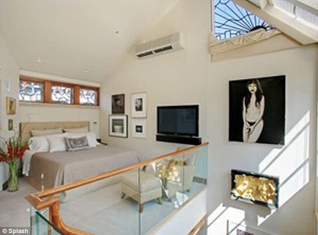 Katy and Russell's master bedroom is perched on the mezzanine level, overlooking the living room.