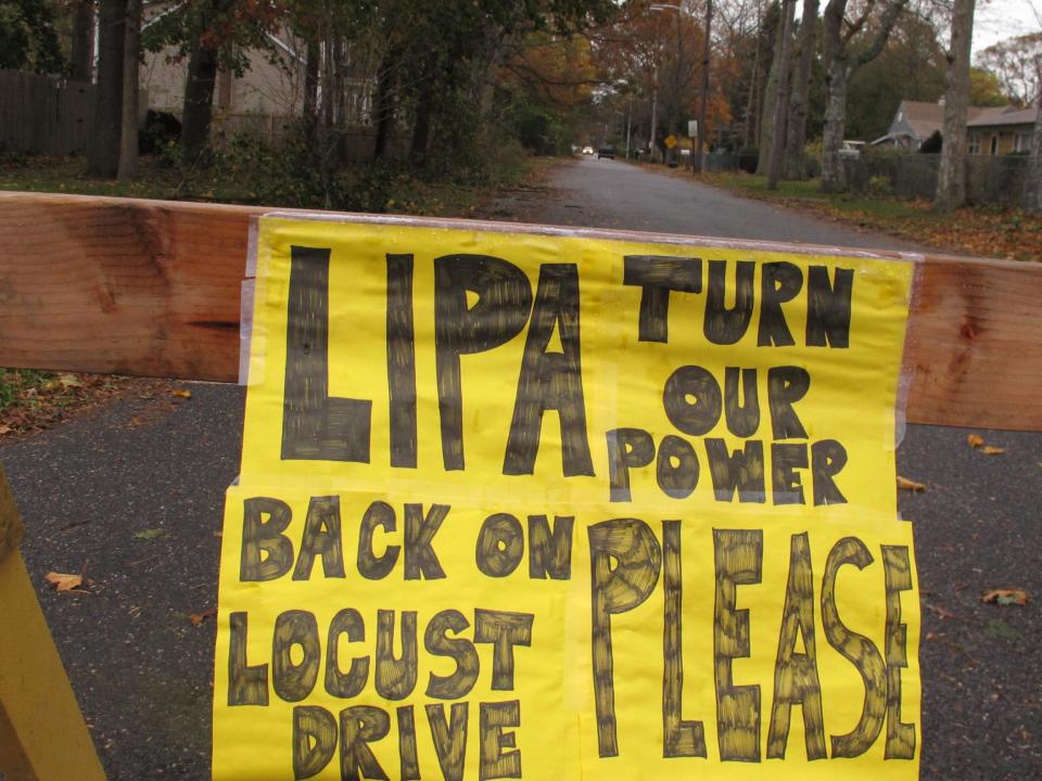 A plea to the Long Island Power Authority for electricity to be restored is posted on a barrier Wednesday, Oct. 31, 2012, in Mastic Beach, N.Y. The south shore Long Island community was among the hardest hit by the storm that pounded the northeast earlier in the week. (AP Photo/Frank Eltman)