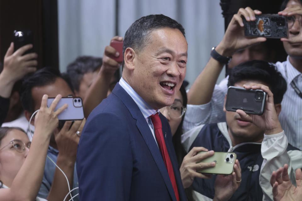 Thai media surround Pheu Thai political party's Srettha Thavisin reacts as he attends a press conference after Thailand's parliament voted in favor of his prime ministerial candidacy, at the party headquarters in Bangkok, Thailand, Tuesday, Aug. 22, 2023. (AP Photo/Wason Wanichakorn)