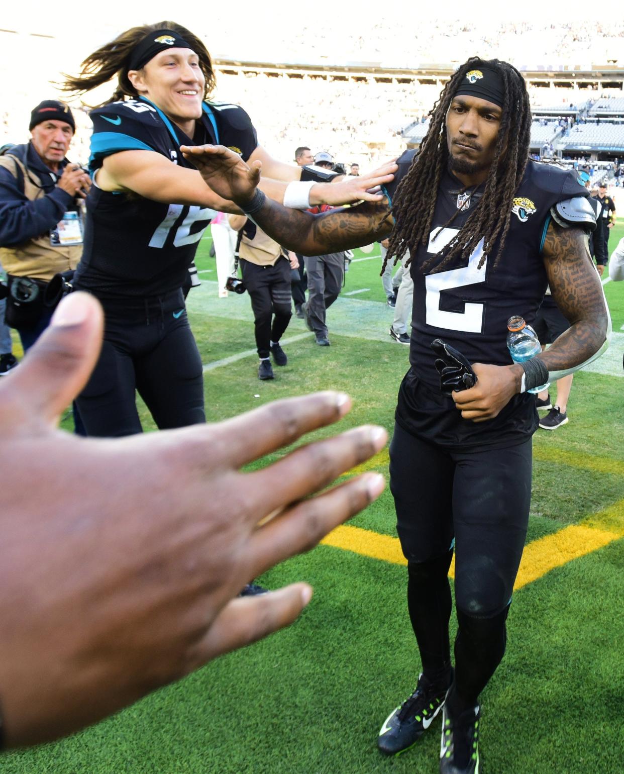 Jacksonville Jaguars quarterback Trevor Lawrence (16) rushes to congratulate teammate safety Rayshawn Jenkins (2) as he leaves the field after the two teamed up on a touchdown pass to win the game in overtime against the Cowboys. The Jacksonville Jaguars hosted the Dallas Cowboys at TIAA Bank Field Sunday, December 18, 2022. The Jaguars trailed 21 to 7 at the half but came back to win 40 to 34 with a pick six by Jacksonville Jaguars safety Rayshawn Jenkins (2) in overtime. [Bob Self/Florida Times-Union]