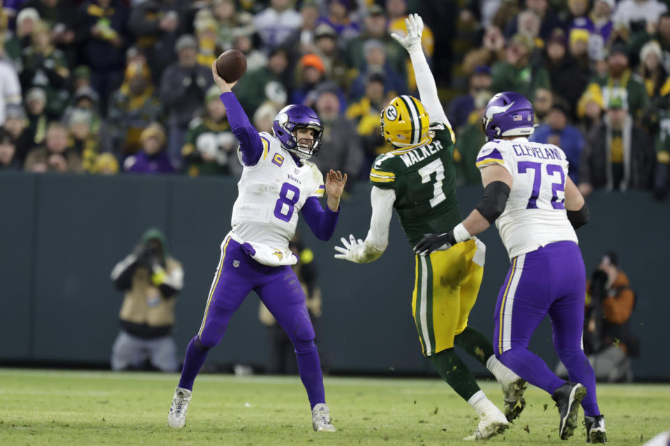 Minnesota Vikings quarterback Kirk Cousins (8) throws a pass over Green Bay Packers linebacker Quay Walker (7) during the first half of an NFL football game, Sunday, Jan. 1, 2023, in Green Bay, Wis. (AP Photo/Matt Ludtke)