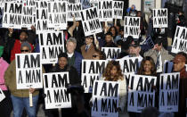 <p>People hold signs, resembling the signs carried by striking sanitation workers in 1968, as they join in events commemorating the 50th anniversary of the assassination of the Rev. Martin Luther King Jr. on Wednesday, April 4, 2018, in Memphis, Tenn. (Photo: Mark Humphrey/AP) </p>
