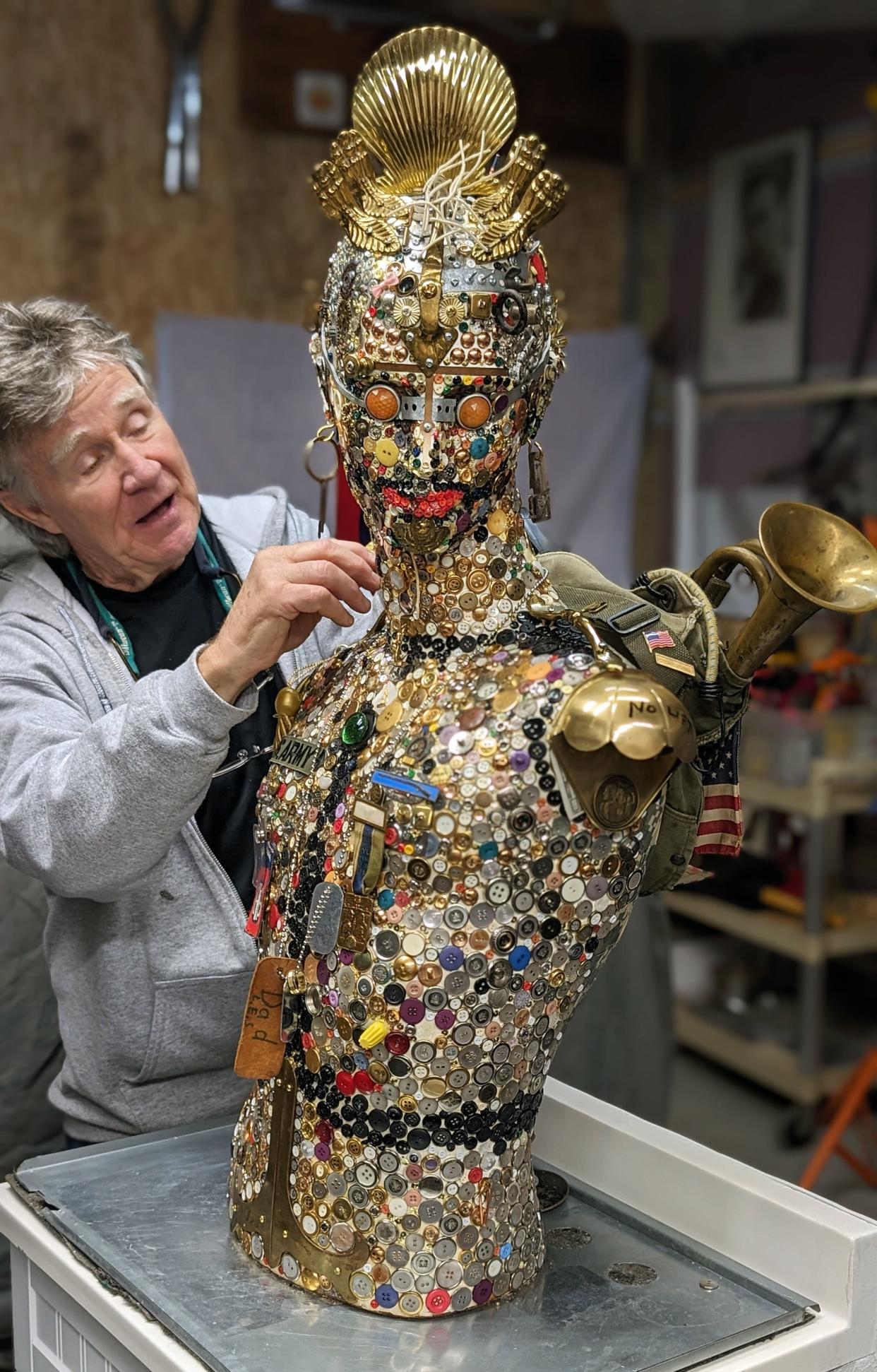 Tom Powers with the sculpture named Point Man 11 Bravo that he created over a 20-year period in his York garage.