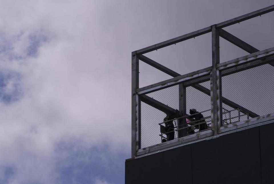 Construction employees work through the late morning heat on the top floor of a new building on W. 21st Street and Guadalupe in Austin’s West Campus neighborhood on July 6, 2023.