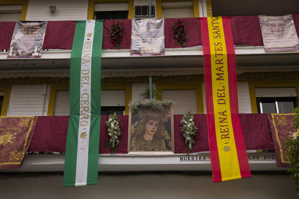 Balconies decorated with Catholic religious banners during the Holy Week in Seville, southern Spain, Tuesday, March 30, 2021. Few Catholics in devout southern Spain would have imagined an April without the pomp and ceremony of Holy Week processions. With the coronavirus pandemic unremitting, they will miss them for a second year. (AP Photo/Laura Leon)