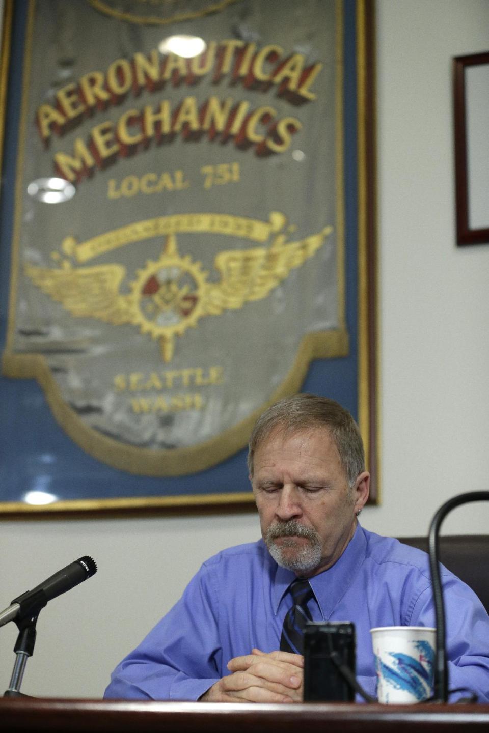 Jim Bearden, administrative assistant for District 751 of the Boeing machinists union, tells reporters that workers voted to accept Boeing's latest contract offer to keep the assembly of the Boeing 777X airplane in Washington state, Friday, Jan. 3, 2014, in Seattle. (AP Photo/Ted S. Warren)