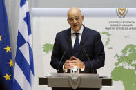 Greek Foreign Minister Nikos Dendias talks to the media during a press conference after a meeting with his Cyprus counterpart Nicos Christodoulides at the foreign ministry house in divided capital Nicosia, Cyprus, Dec. 4, 2020. Dendias and Christodoulides were meeting to coordinate their course of action ahead of a summit of European Union leaders next week to decide on a Turkish hydrocarbons search in waters where Cyprus and Greece claim exclusive rights and which EU officials have called " provocative"and "unlawful." (AP Photo/Petros Karadjias, Pool)