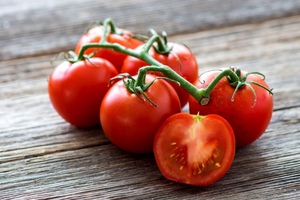 fresh tomatoes on wood background