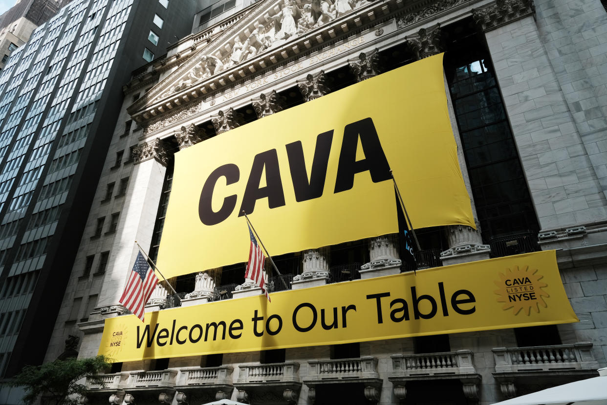 NEW YORK, NEW YORK - JUNE 15: A banner for the Mediterranean restaurant chain Cava is displayed outside of the New York Stock Exchange (NYSE) as the company goes public on June 15, 2023 in New York City.  Cava priced its IPO at $22 per share, valuing the company at $2.5 billion.  (Photo by Spencer Platt/Getty Images)