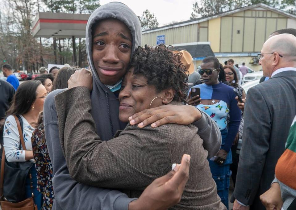 Sonya Williams, the mother of Darryl Williams, embraces Zayvien Williams, Darryl Williams’ brother, after laying a bouquet of flowers at a memorial on Rocky Quarry Road on Thursday, February 16. 2023 in Raleigh, near were Darryl Williams died after being tased by the Raleigh Police Department.