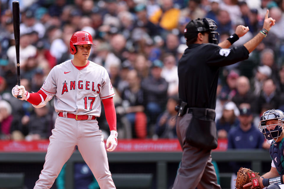 SEATTLE, WASHINGTON - APRIL 05: Umpire Pat Hoberg #31 calls Shohei Ohtani #17 of the Los Angeles Angels for a pitch clock violation during the sixth inning against the Seattle Mariners at T-Mobile Park on April 05, 2023 in Seattle, Washington. (Photo by Steph Chambers/Getty Images)