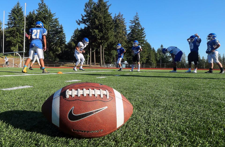 The Olympic Trojans football team runs through drills during practice on Monday, Aug. 22, 2022.