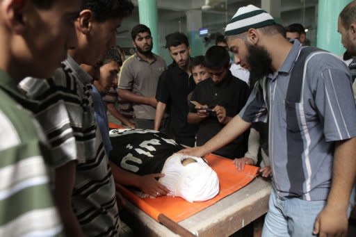 Relatives and friends mourn over the body of 21-year-old Ghaleb Ermilat during his funeral in Rafah. Ermilat was named a "global jihad" operative by the Israeli military, who say he put together a deadly ambush on Israel's border with Egypt