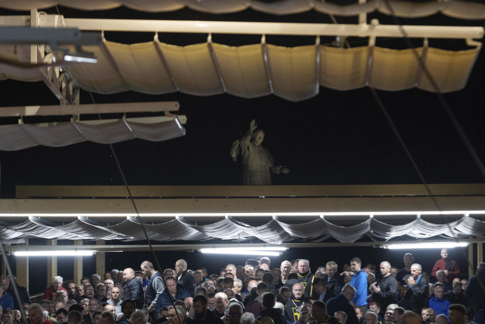 People attend an evening Mass celebration at the Jasna Gora Monastery, Poland's most revered Catholic shrine, in Czestochowa, Poland, Saturday, Sept. 23, 2023. As the ruling conservative Law and Justice party seeks to win an unprecedented third straight term in the Oct. 15 parliamentary election, it has sought to bolster its image as a defender of Christian values and traditional morality. Yet more and more Poles appear to be questioning their relationship with the Catholic church, and some cite its closeness to the government as a key reason. (AP Photo/Michal Dyjuk)