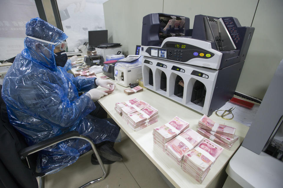 SHANXI, CHINA - FEBRUARY 24: (CHINA MAINLAND OUT)The bank workers sanitize the cash to kill the novel coronavirus on 24th February, 2020 in Taiyuan,Shanxi,China.(Photo by TPG/Getty Images)