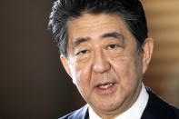 Japan's outgoing Prime Minister Shinzo Abe speaks to the media as he arrives at the prime minister's office for a cabinet meeting Wednesday, Sept. 16, 2020, in Tokyo. Abe and his Cabinet resigned, clearing the way for his successor Yoshihide Suga to take over after parliamentary confirmation later in the day. (AP Photo/Eugene Hoshiko)