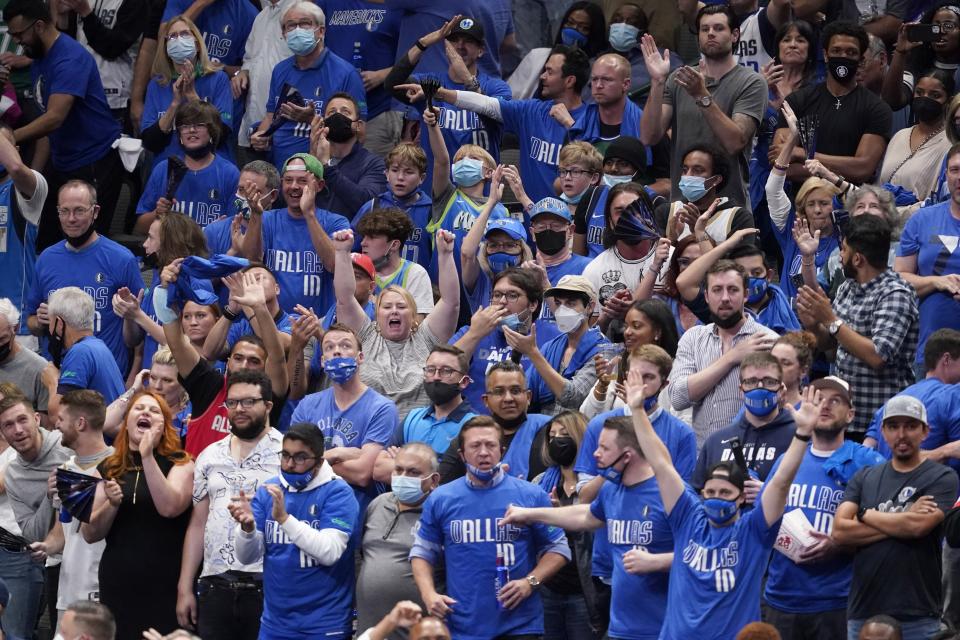 Fans cheer as the Dallas Mavericks play the Los Angeles Clippers in the second half in Game 3 of an NBA basketball first-round playoff series in Dallas, Friday, May 28, 2021. (AP Photo/Tony Gutierrez)