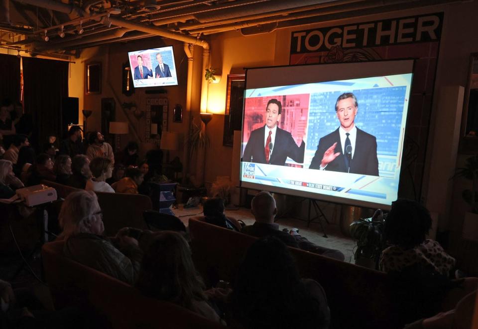 Ron DeSantis and Gavin Newsom debate on Fox News on 30 November (Getty Images)