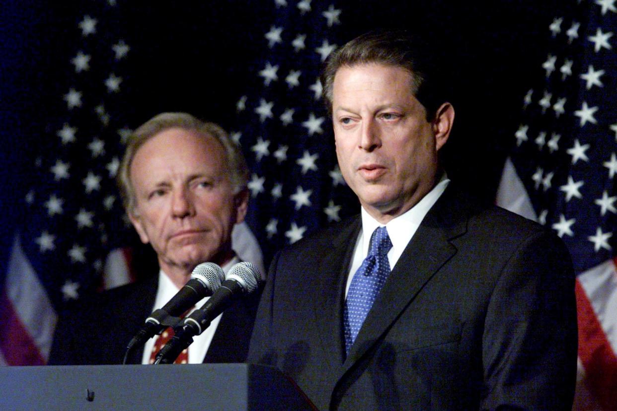 Democratic presidential candidate Vice President Al Gore, right, accompanied by running mate Sen. Joseph Lieberman, addresses the media gathered at the Lowe's Vanderbilt Plaza the day after the elections Nov. 8, 2000. Both Gore and Republican candidate George W. Bush stood poised to claim the presidency as Florida election officials continued to recount votes.