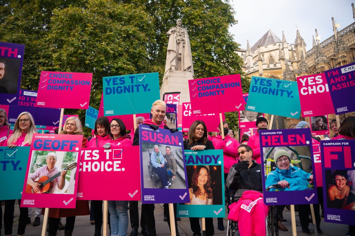 Demonstrators including Humanists UK members and supporters during a protest outside the Houses of Parliament to call for reform as peers debated the new assisted dying legislation in October 2021 (PA)