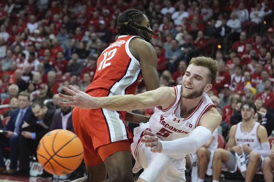 Wisconsin's Tyler Wahl passes around Ohio State's Evan Mahaffey during the second half of an NCAA college basketball game Tuesday, Feb. 13, 2024, in Madison, Wis. (AP Photo/Morry Gash)