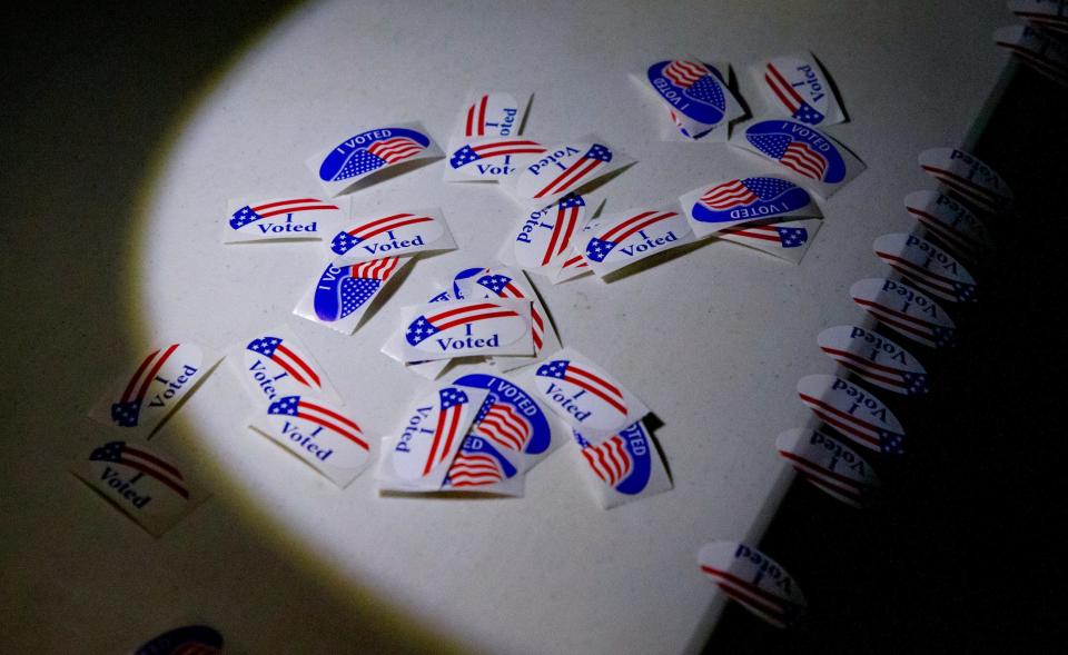 Stickers rest on a table for voters after casting their ballots for the general election Tuesday, Nov. 8, 2022, at Canadian Hills Church of the Nazarene in Yukon.